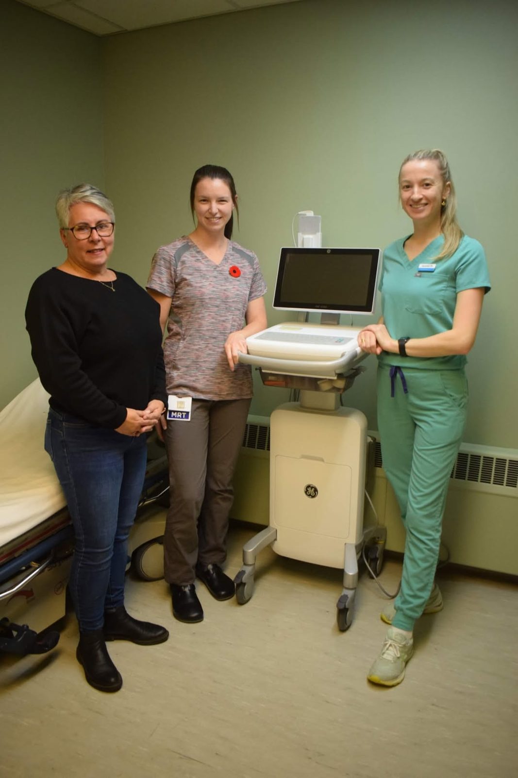 Judy Hennessey with MRT Meranda Hendricken and RN Samantha Cottreau beside the new EKG system