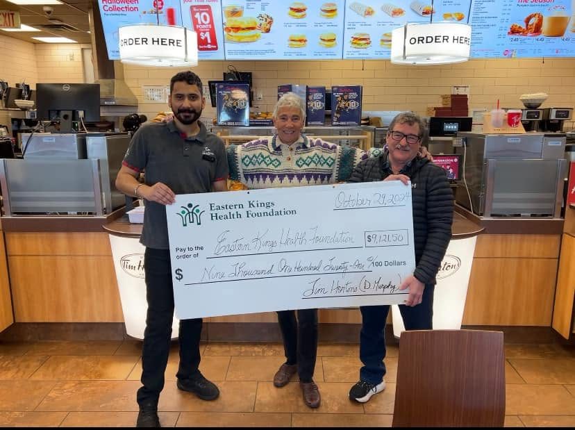Allie Gallant and Gail Dingwell-MacInnis accept the $9,121.50 Smile Cookie cheque at Souris Tim Hortons